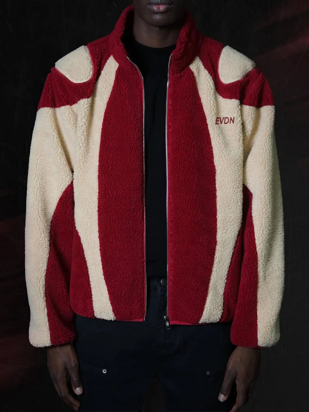 Red and beige striped jacket with 'EVDN' branding on a dark background