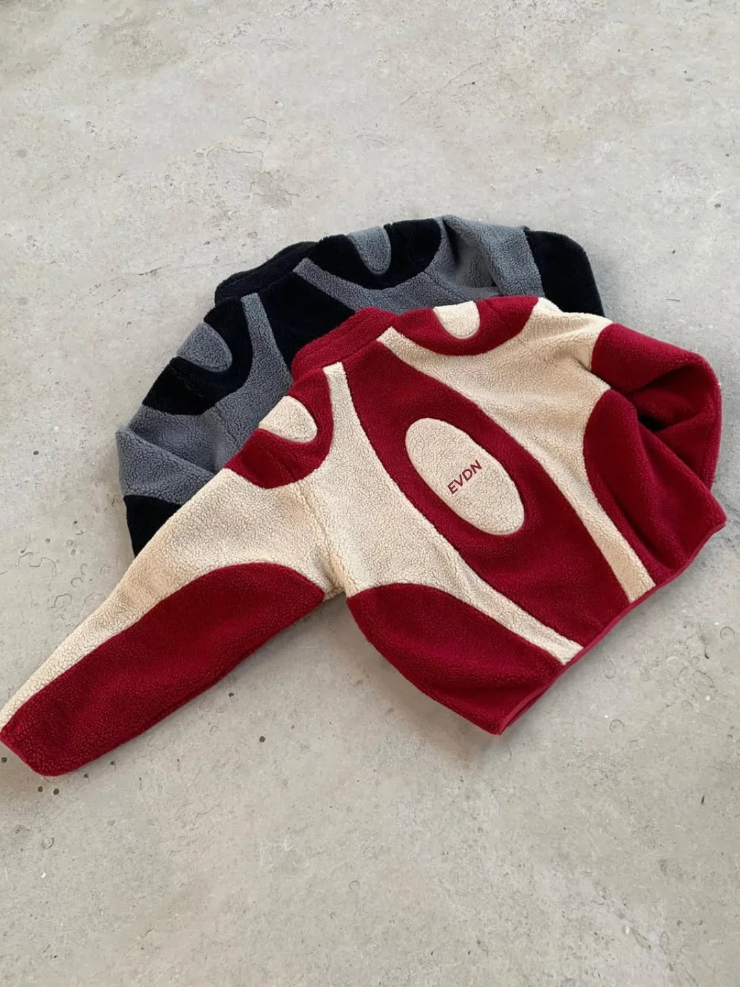 Three pairs of socks with different color patterns on a light gray surface