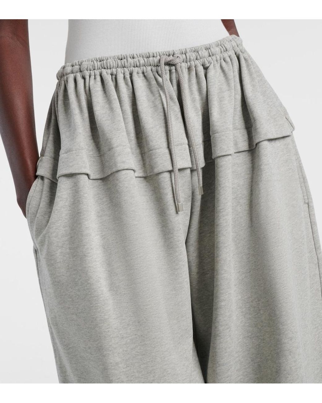 Grey layered pants on a mannequin against a white background