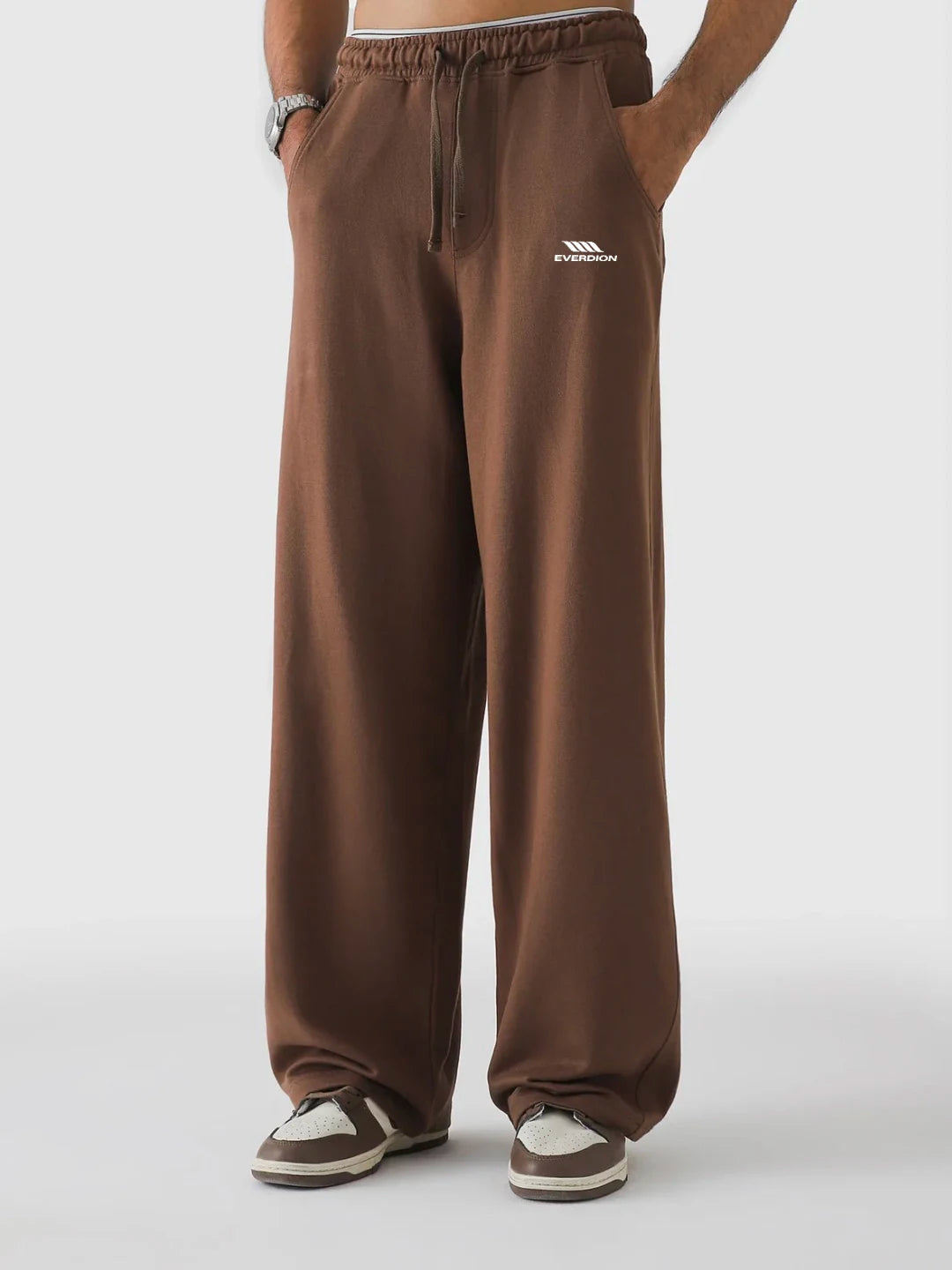 Brown sweatpants with a brand logo on a white background
