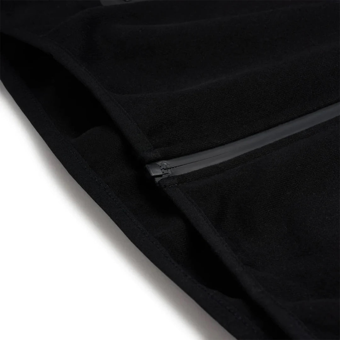 Close-up of a black zipper on a black fabric background