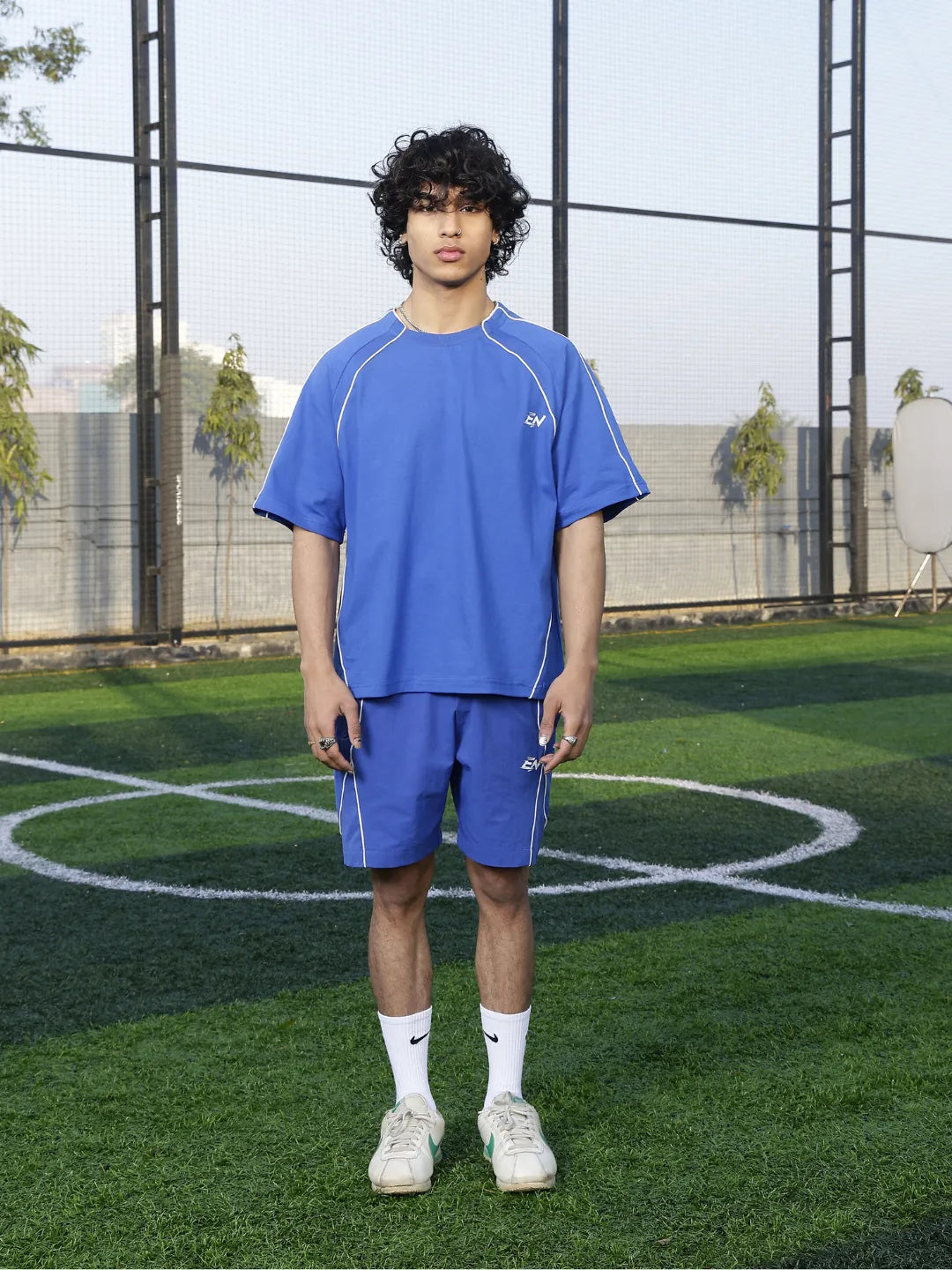 Person wearing a blue athletic outfit on a sports field
