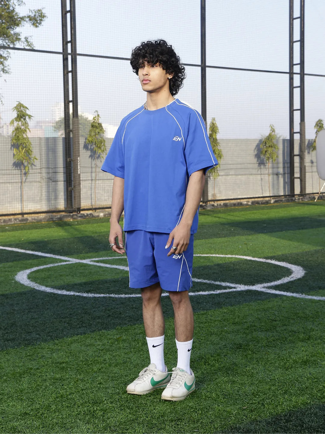 Person wearing a blue sports outfit on a grassy field
