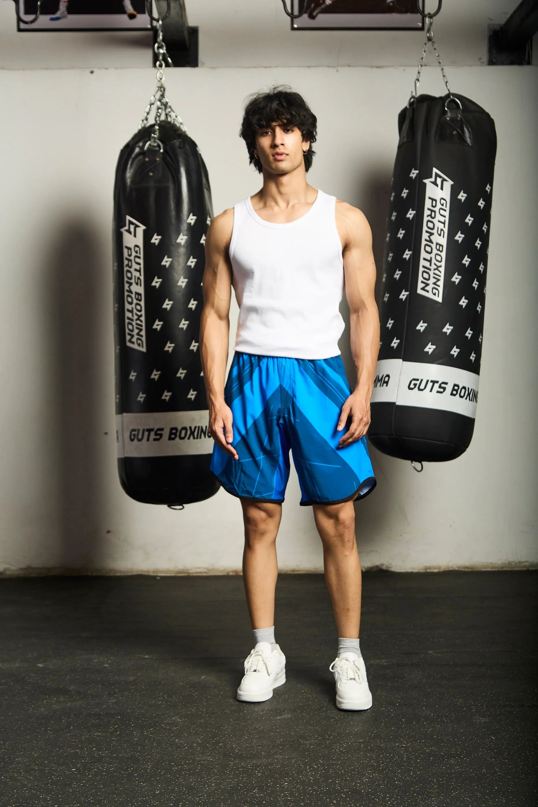 Person wearing blue Upshift MMA Shorts with Everdion logo