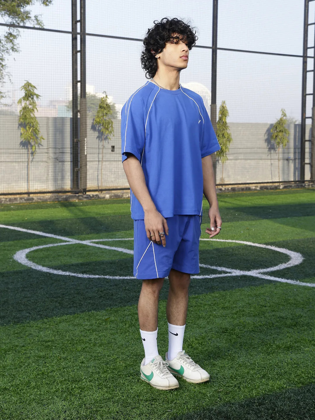 Person wearing a blue sports outfit on a grassy field