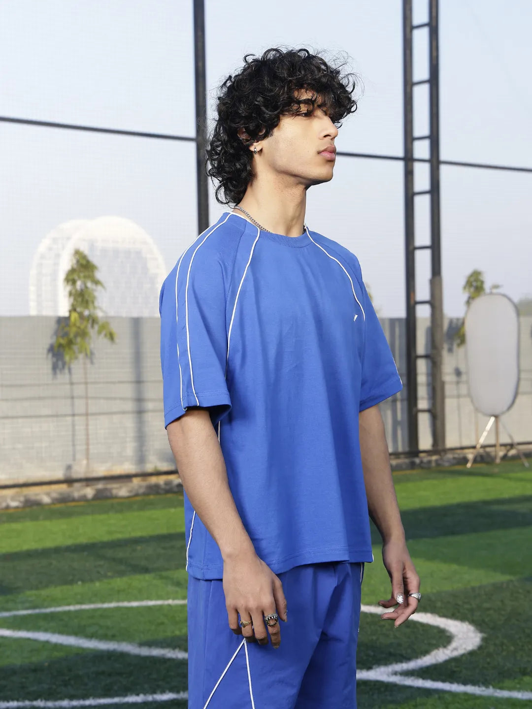Person wearing a blue sports t-shirt  on a sports field