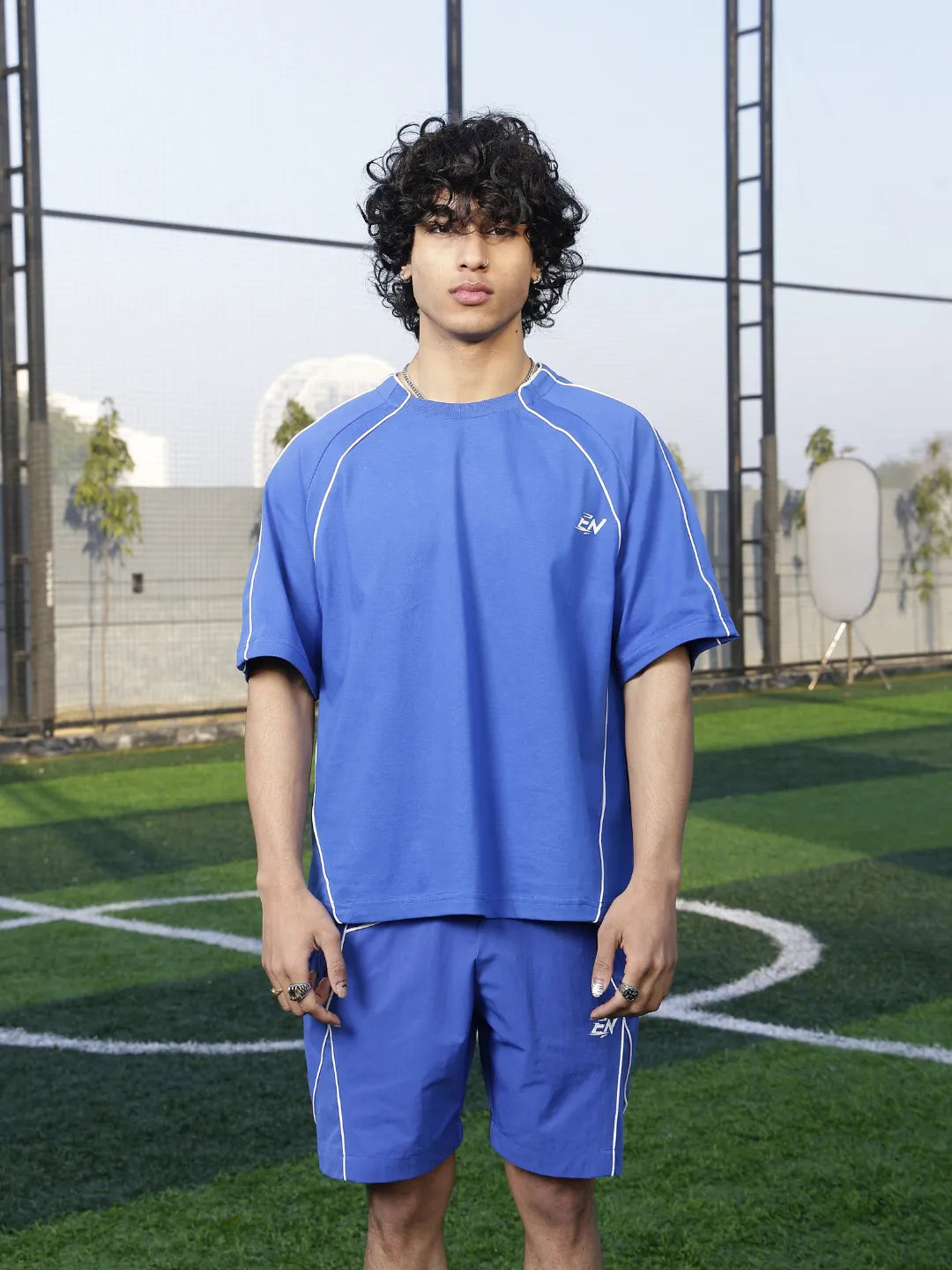 Person wearing a blue sports outfit on a grassy field