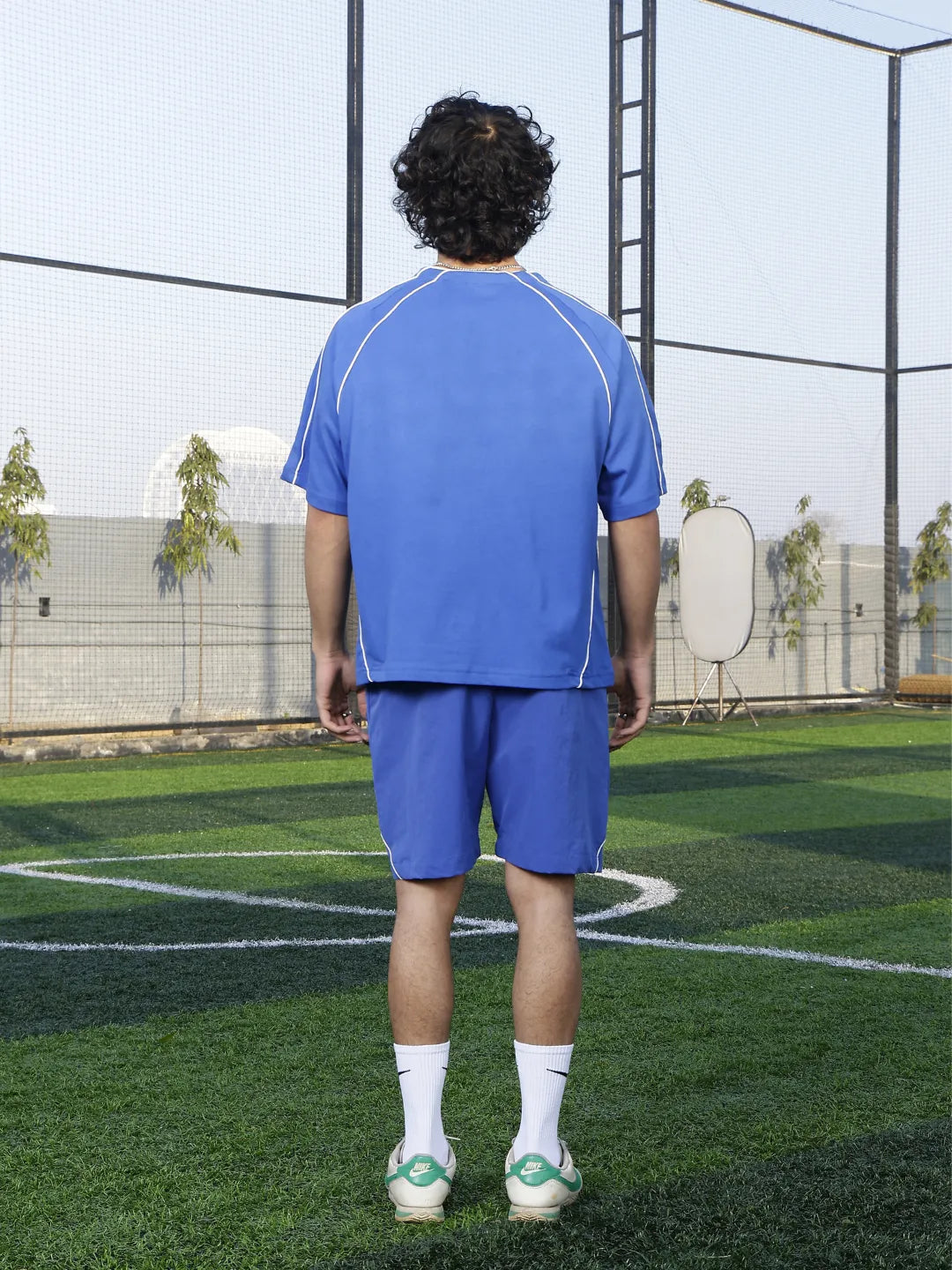 Person wearing a blue sports outfit on a grassy field