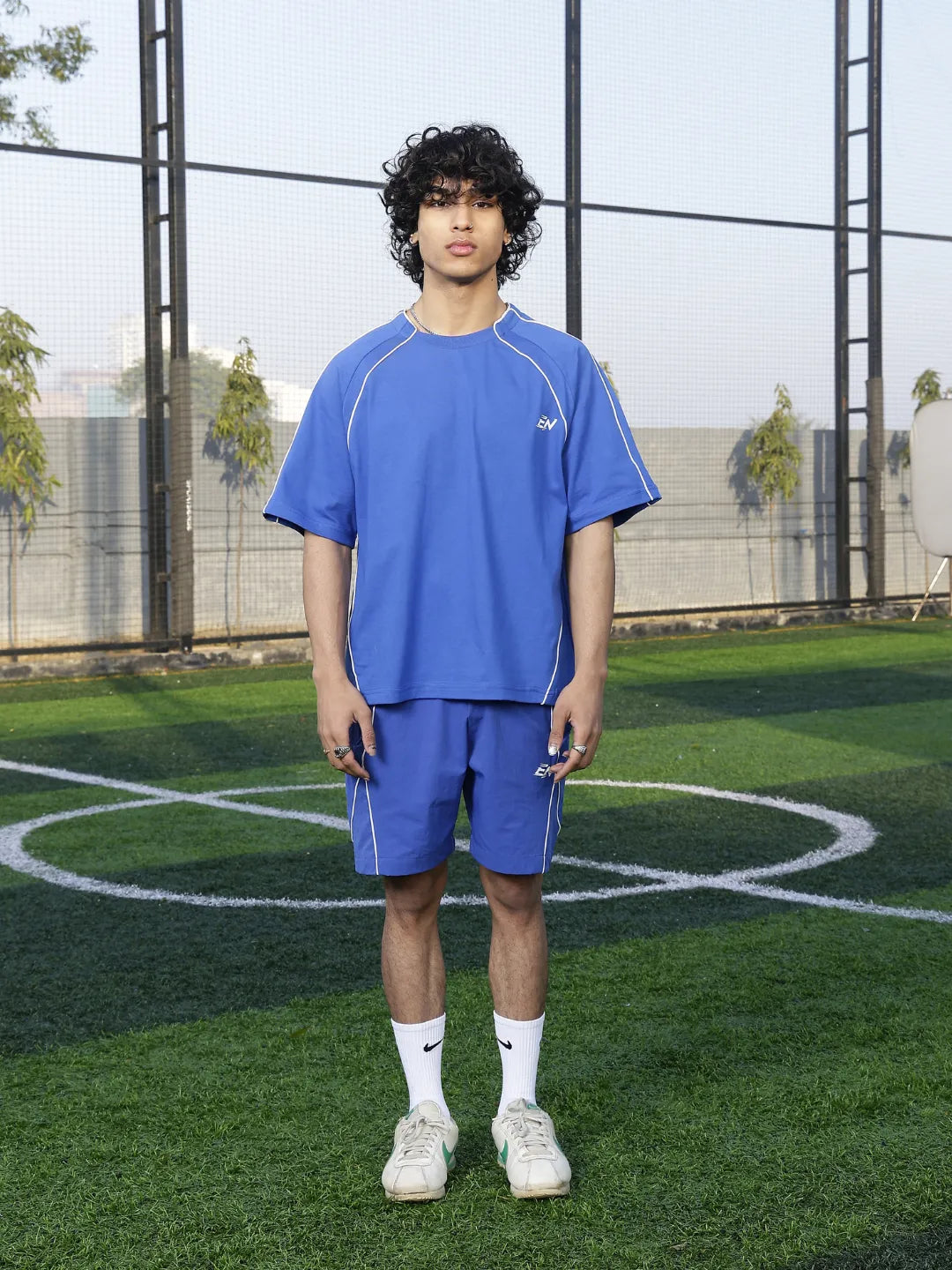 Person wearing a blue athletic t-shirt on a sports court