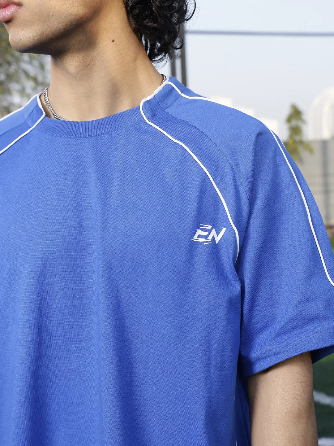 Person wearing a blue sports outfit on a grassy field