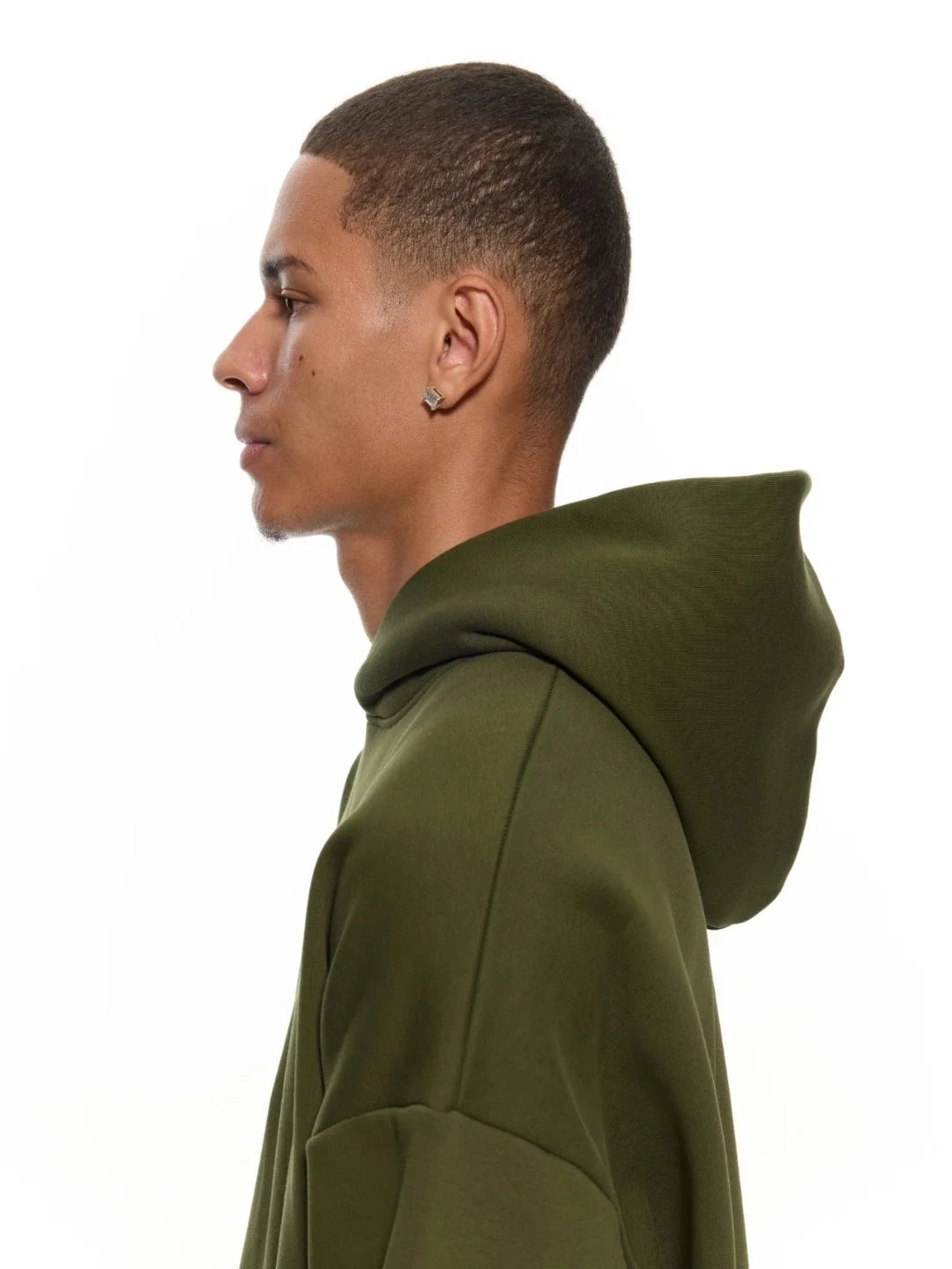 Person wearing a green hoodie on a white background
