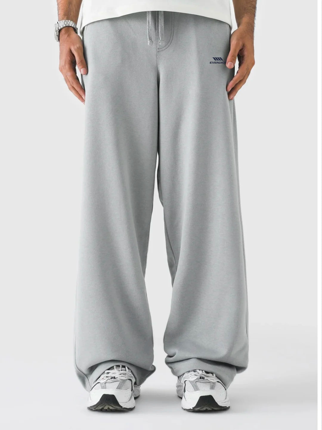 Person wearing grey sweatpants on a white background