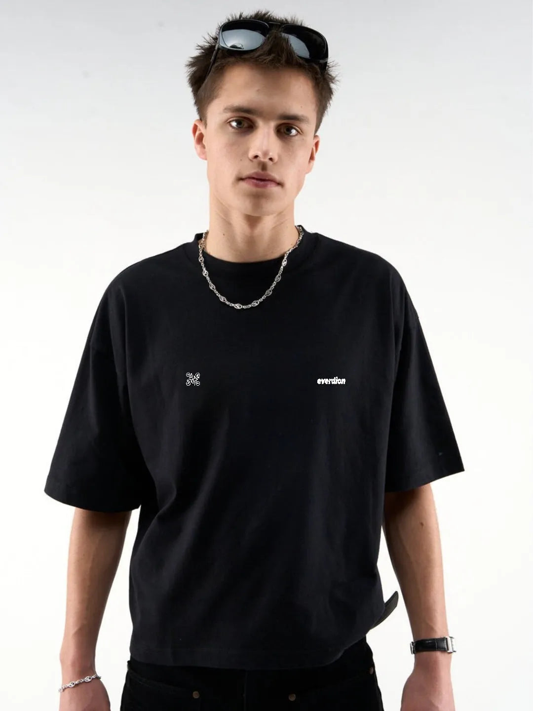 Person wearing a black t-shirt with a logo on a white background