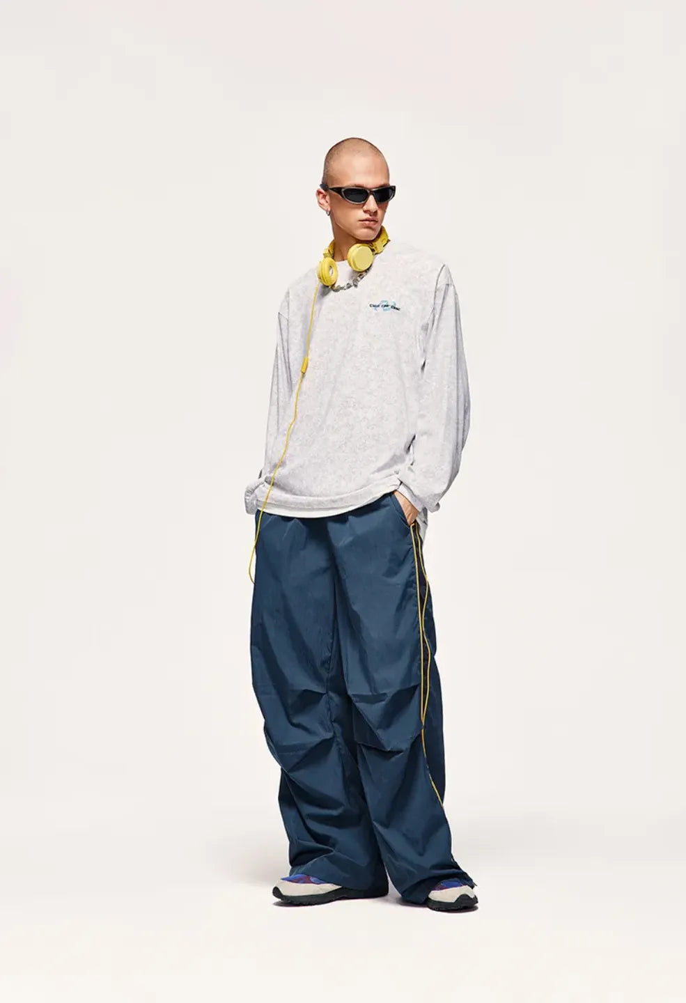 Person wearing a white jacket and blue pants on a white background