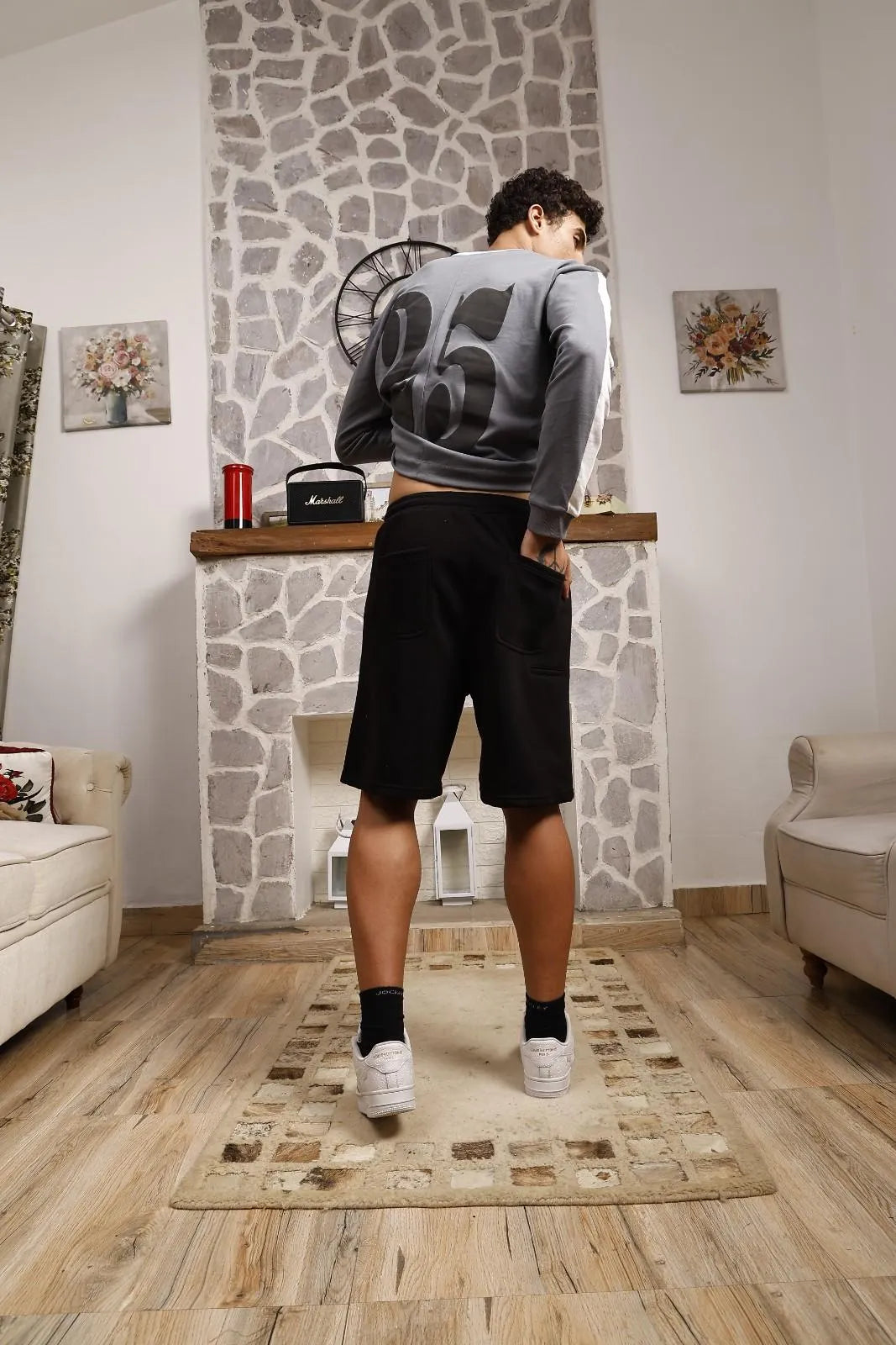 Person wearing black sweat shorts