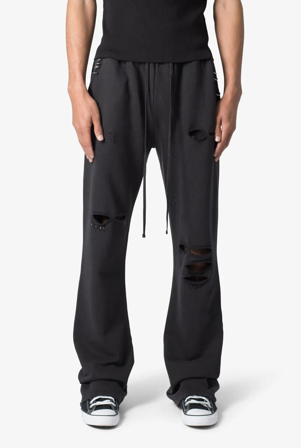 Person wearing black sweatpants on a white background