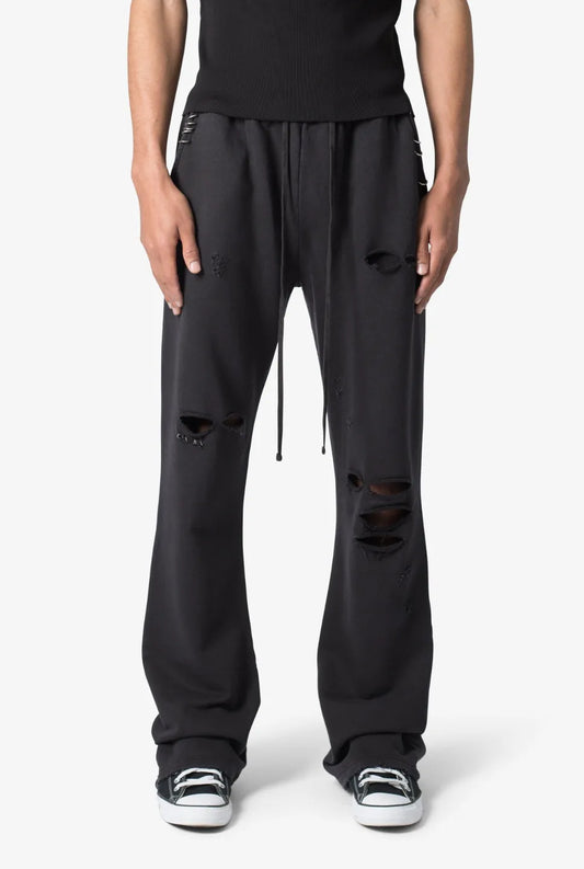 Person wearing black sweatpants on a white background