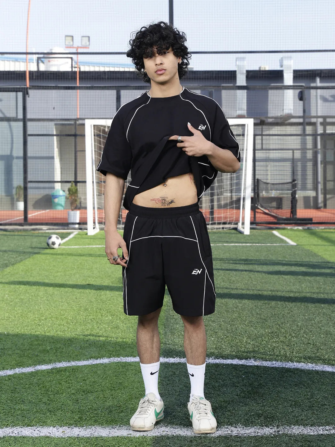 Person wearing a black outfit on a sports field