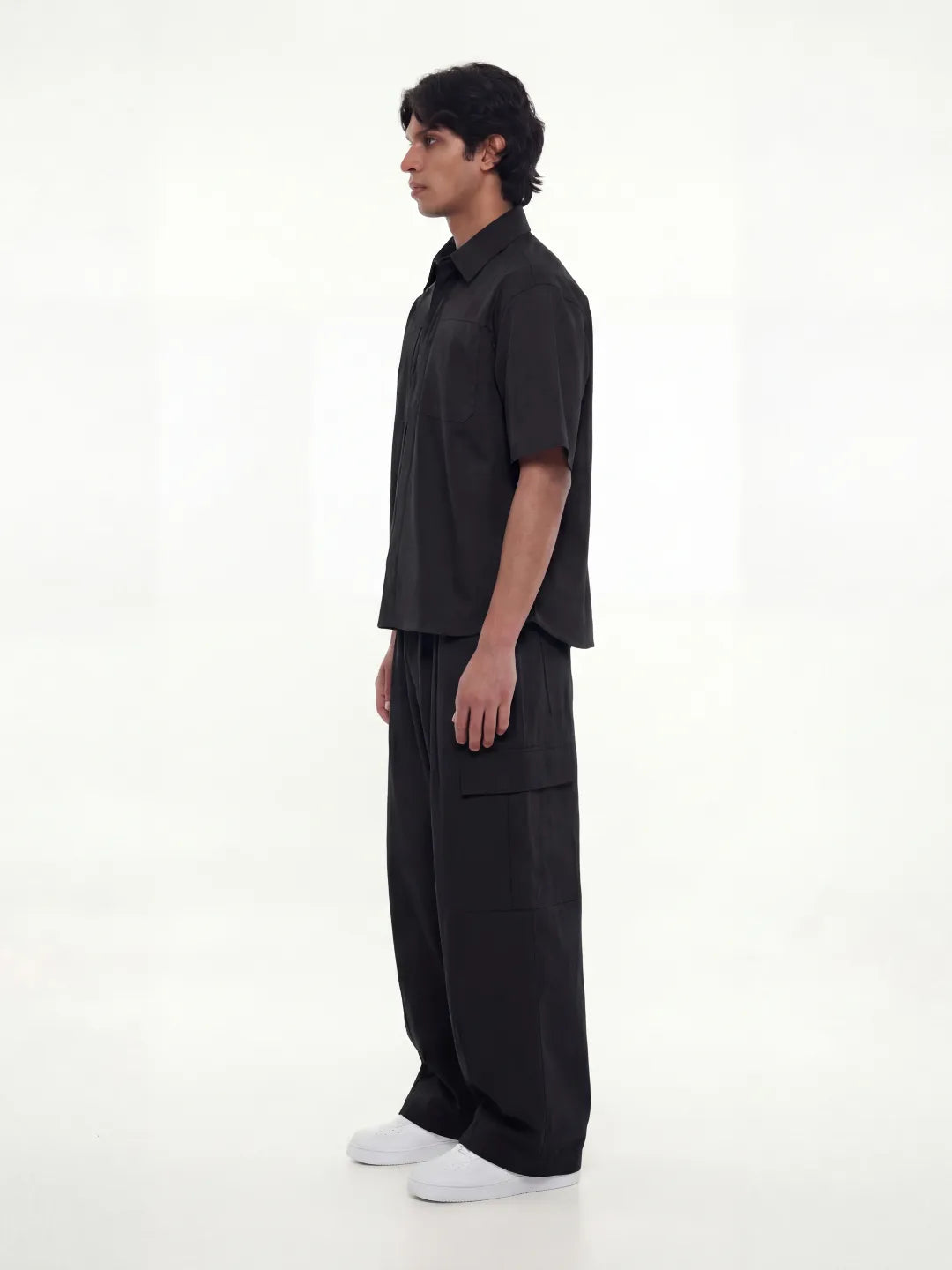 Person wearing a black outfit on a white background