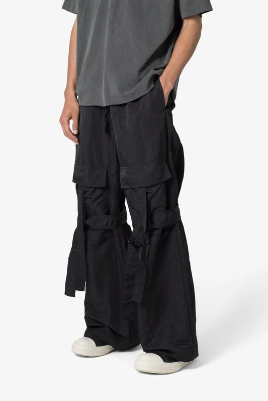 Person wearing black baggy strap cargo pants 