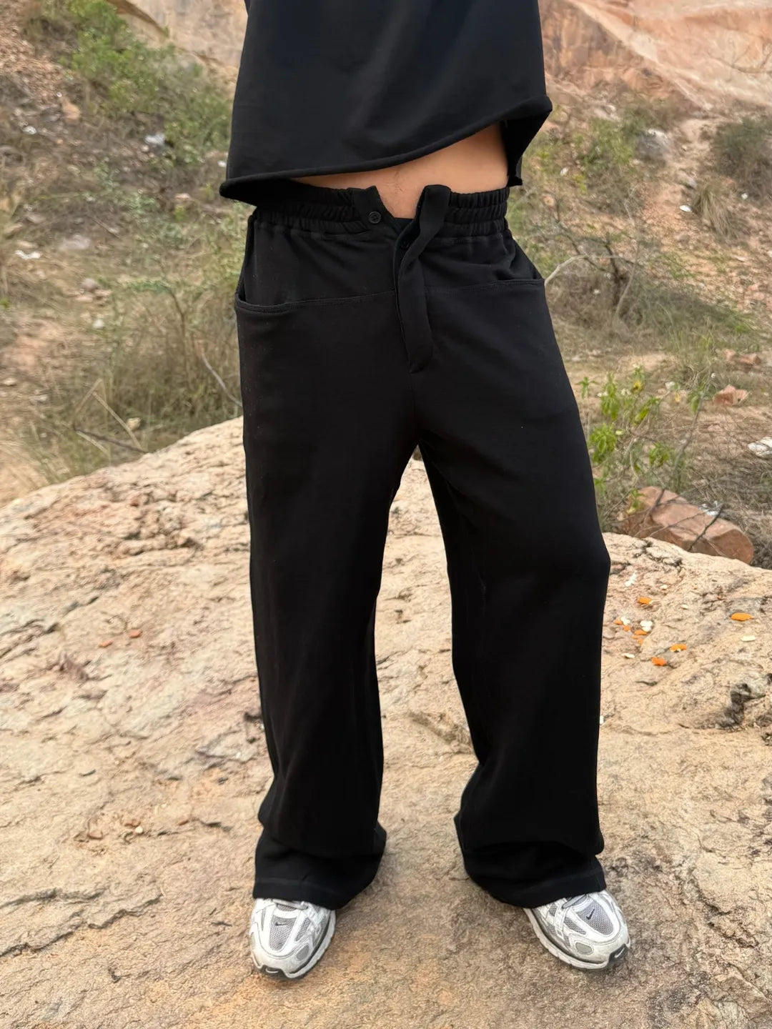 Person wearing button up black sweatpants 