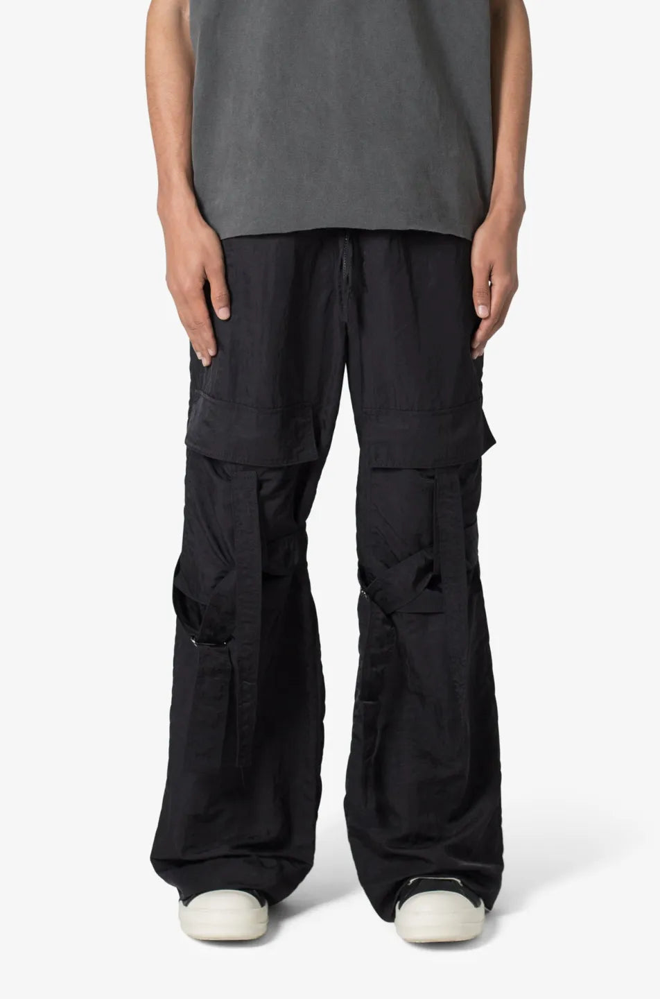 Person wearing black baggy strap cargo pants 