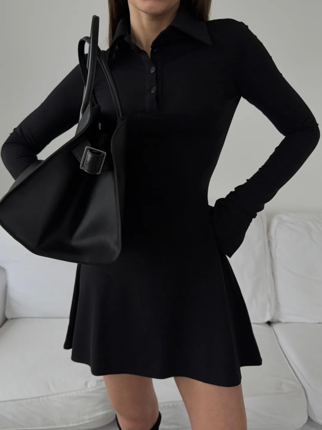 Person wearing a black business dress 