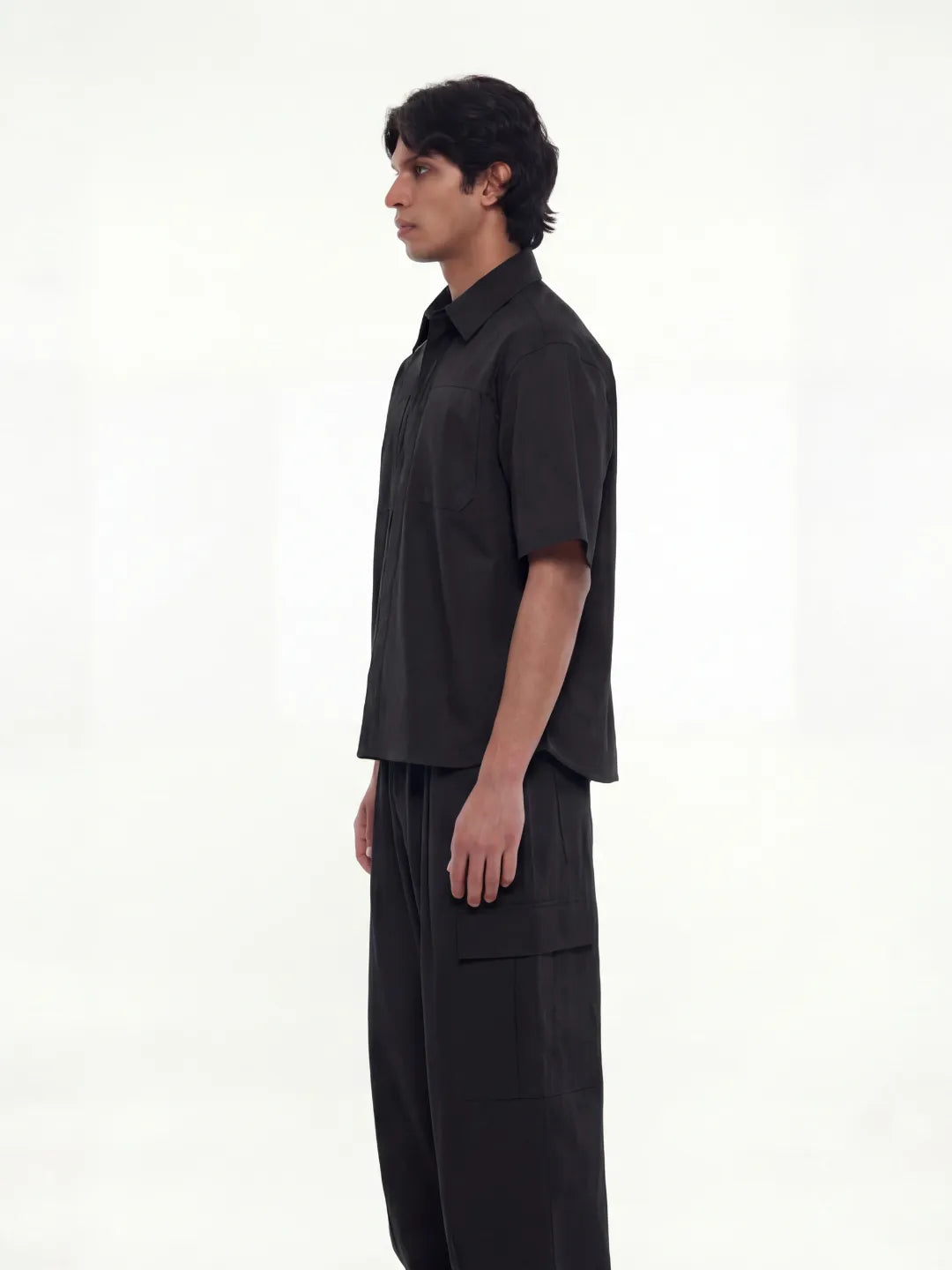 Person wearing a black outfit on a white background