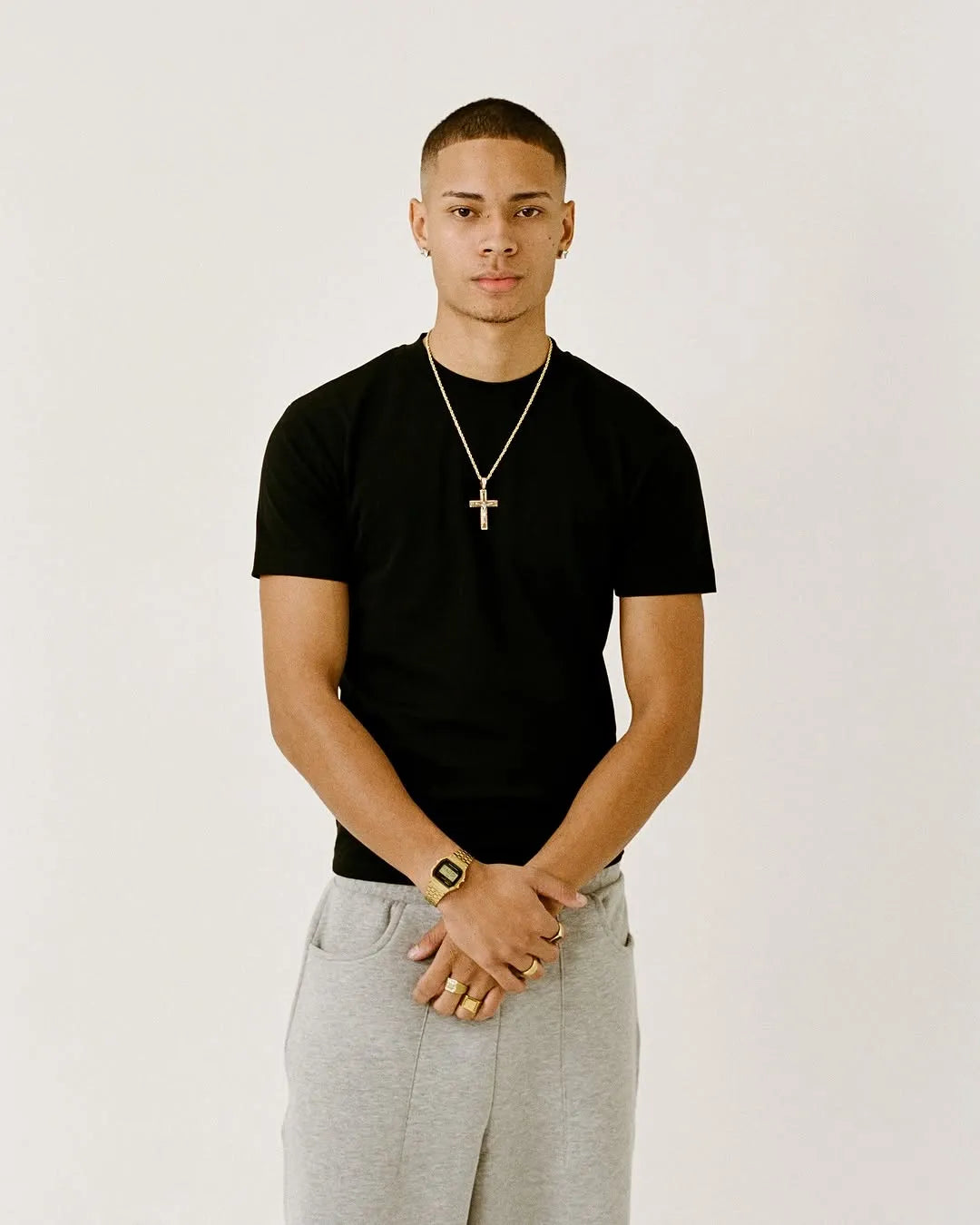 Man wearing a black fitted t-shirt, grey pants