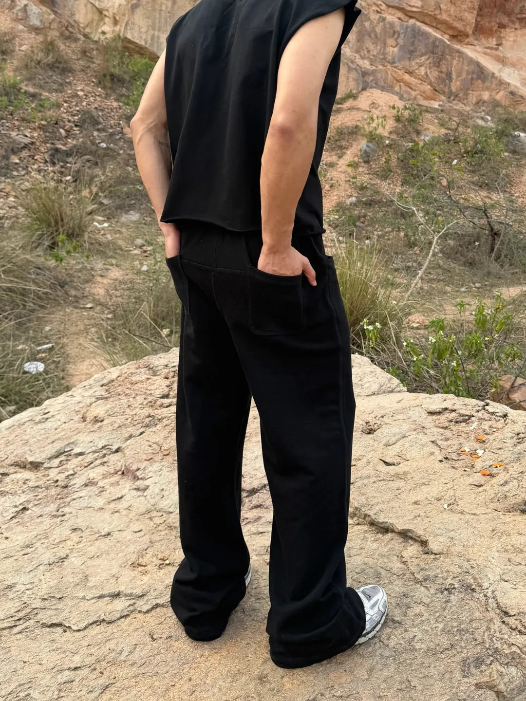 Person wearing button up black sweatpants 