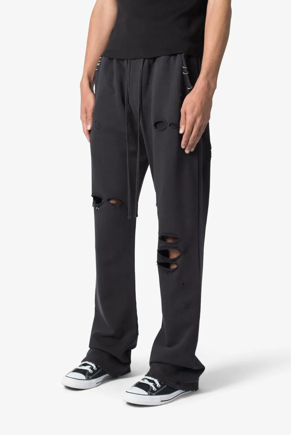Person wearing black sweatpants on a white background