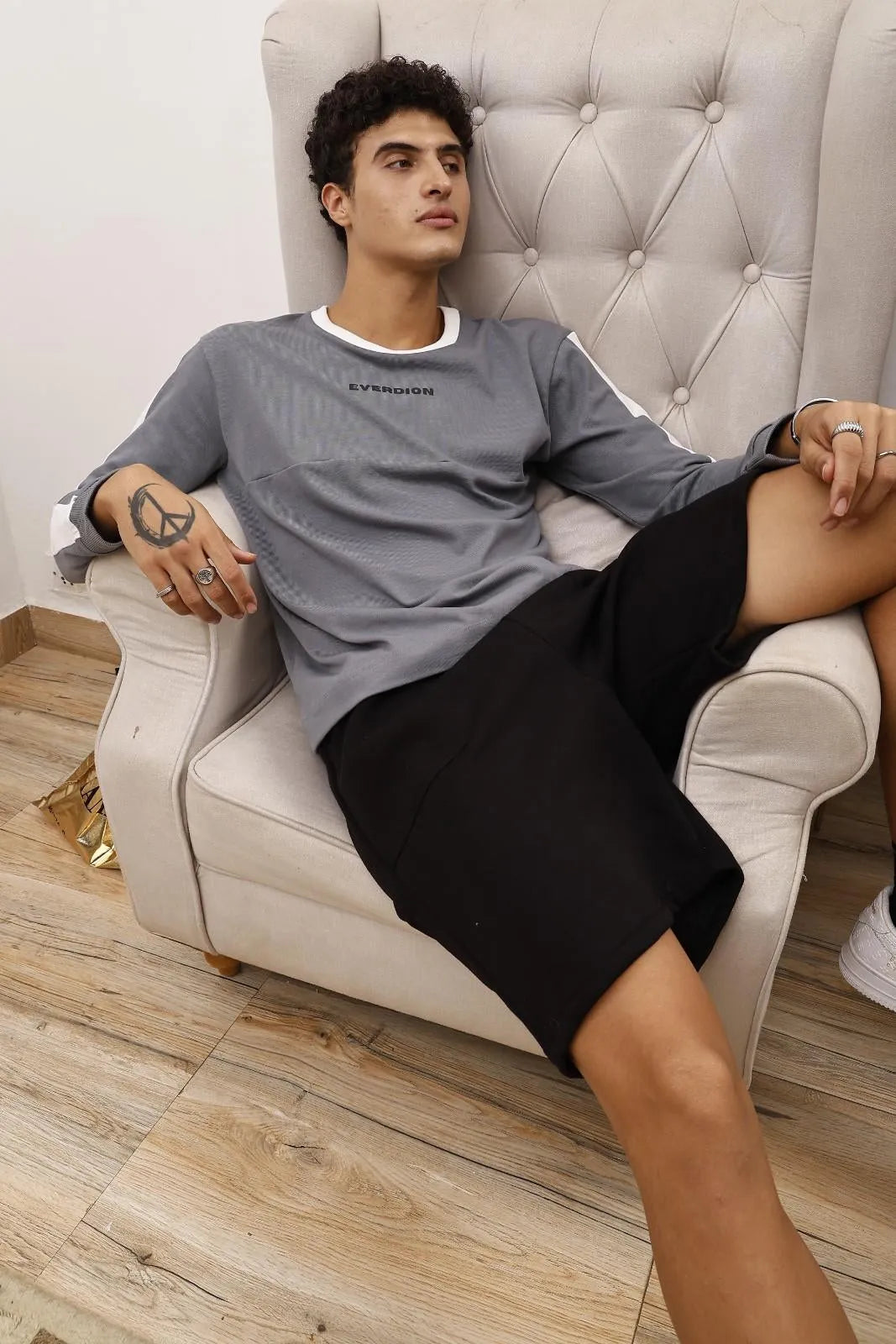 Person wearing black sweat shorts 