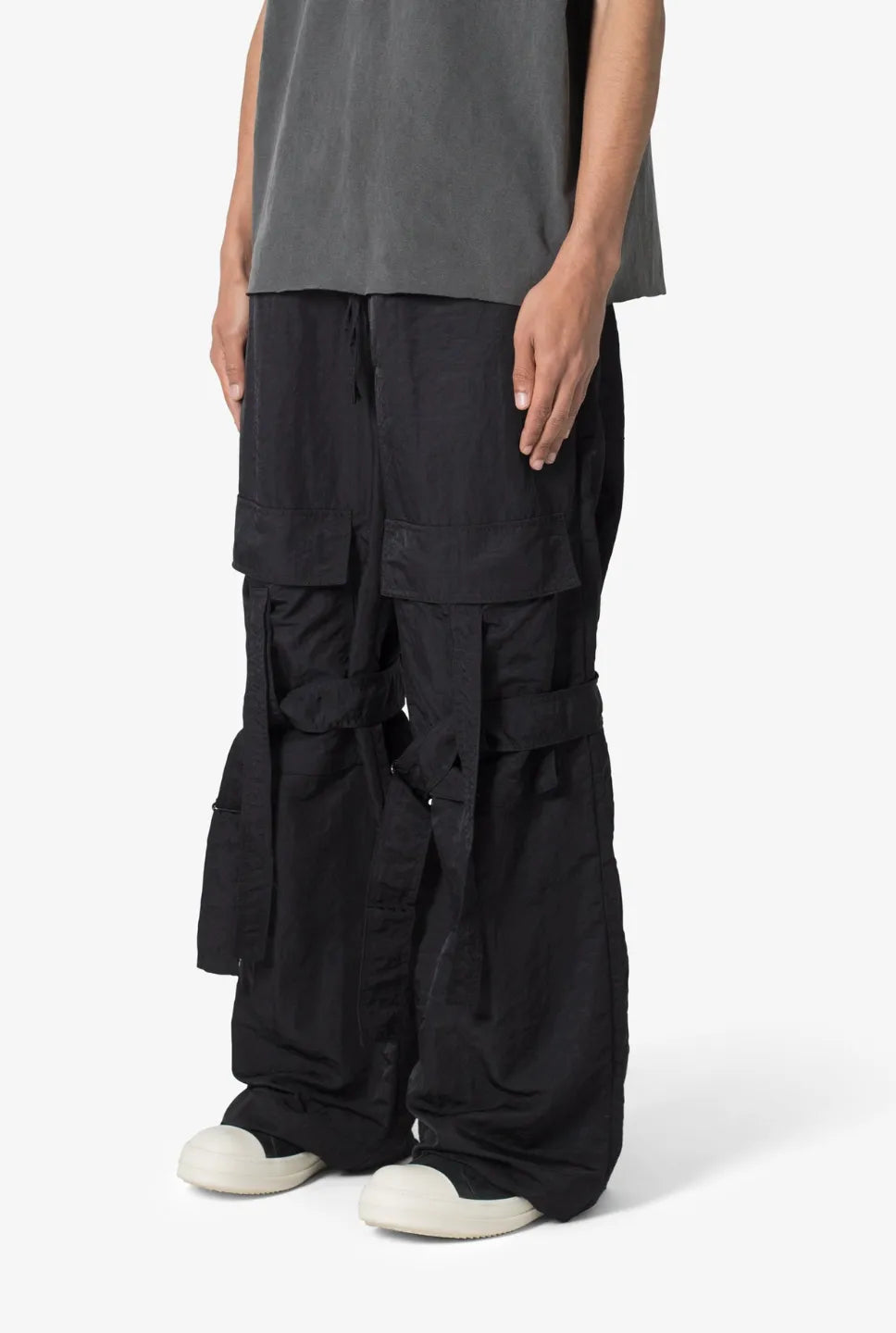 Person wearing black baggy strap cargo pants 