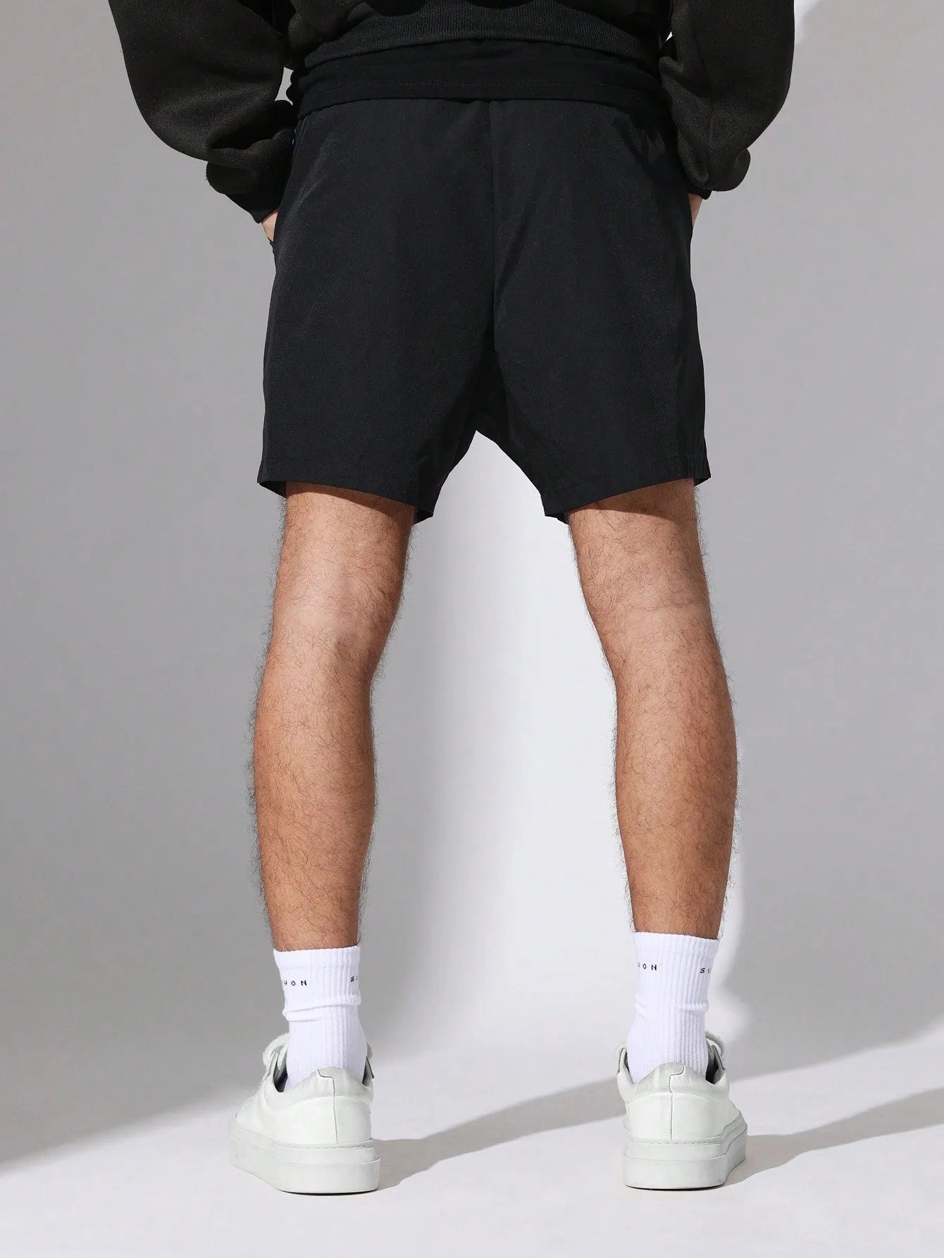Person wearing black Nylon Race Shorts