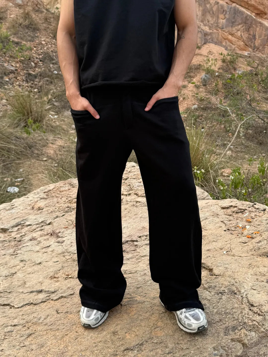 Person wearing button up black sweatpants 