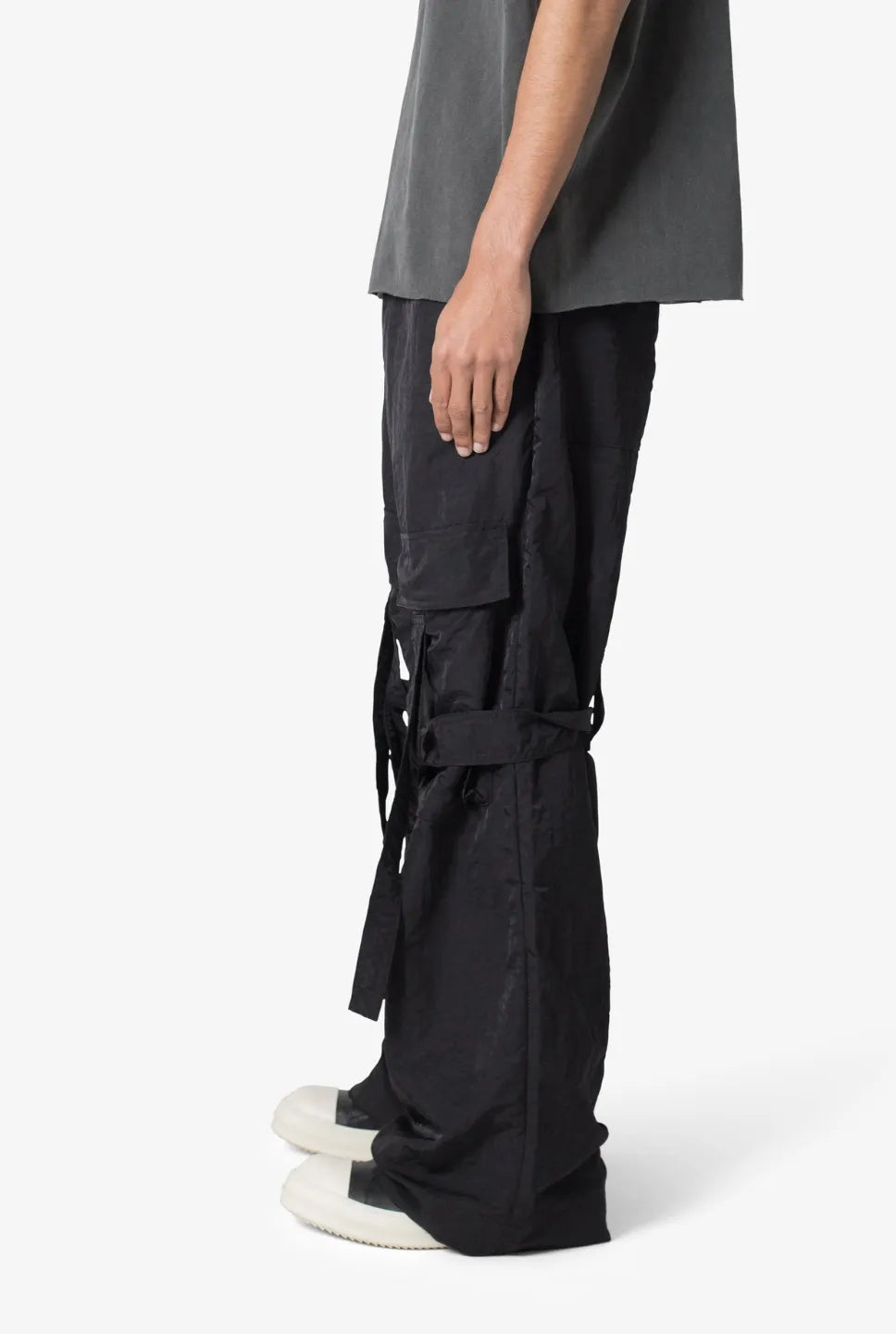 Person wearing black baggy strap cargo pants 