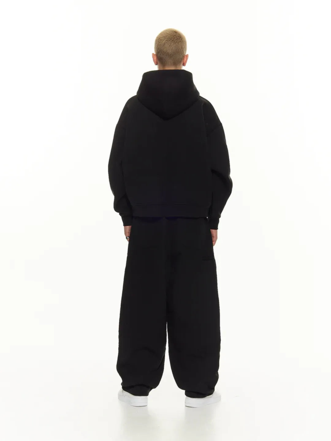 Person wearing a zip-up jacket on a white background