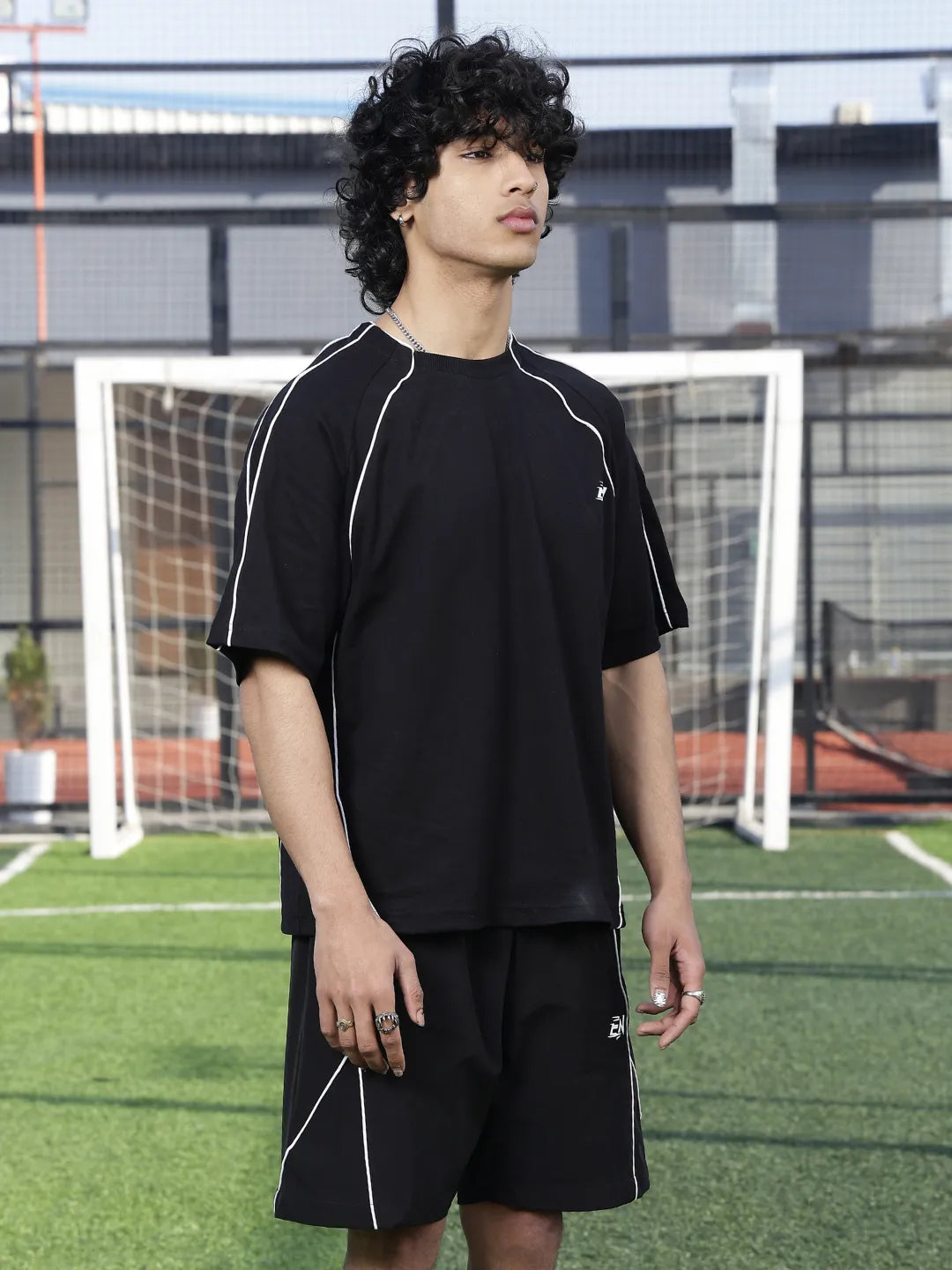 Person wearing a black sports outfit on a soccer field