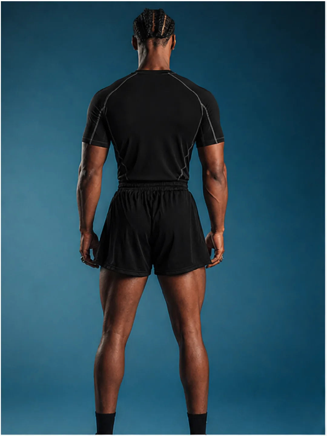 Person wearing a black athletic t-shirt on a blue background