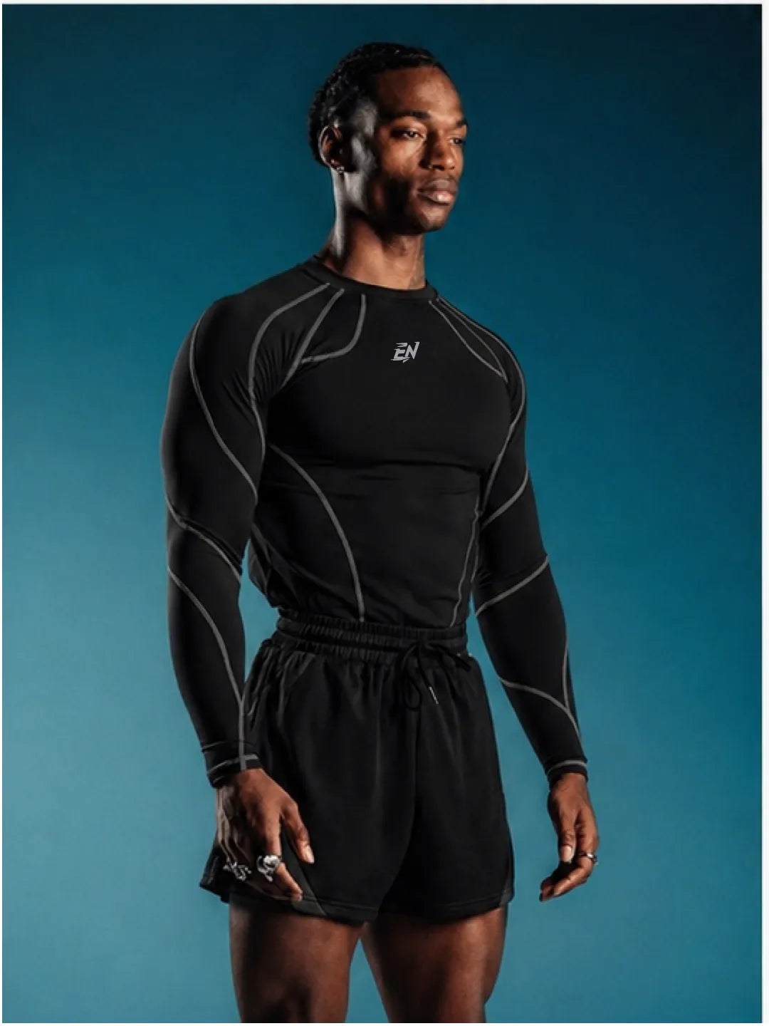 Person wearing a black Compression Full Sleeve T-shirt with a brand logo on a blue background