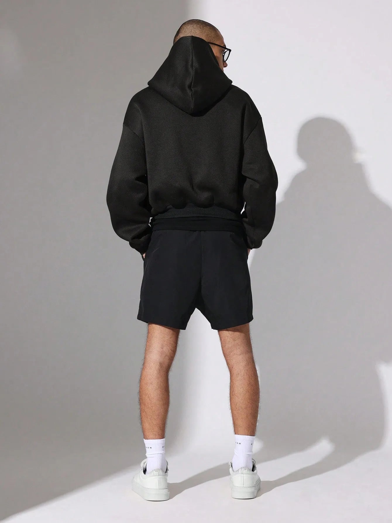 Person wearing black Nylon Race Shorts