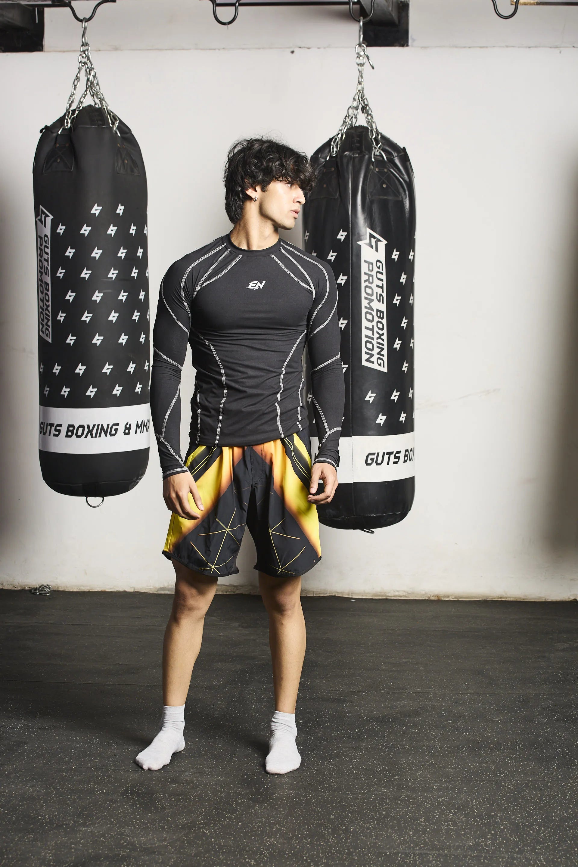 Person wearing black Upshift MMA Shorts with Everdion logo