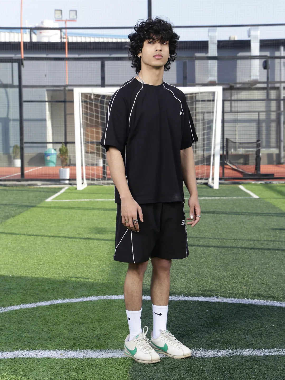 Person wearing a black sports outfit on a grassy field