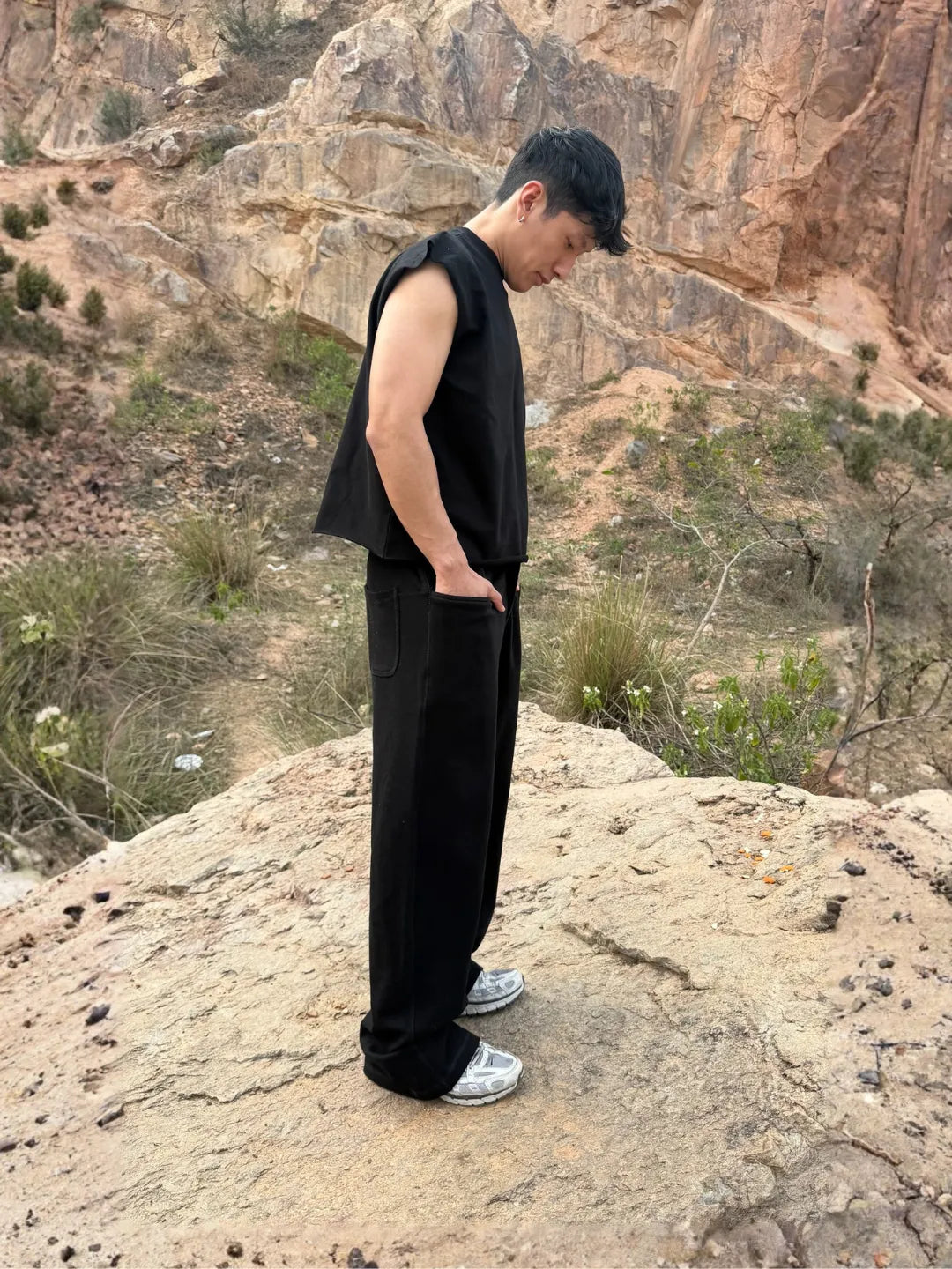 Person wearing button up black sweatpants 