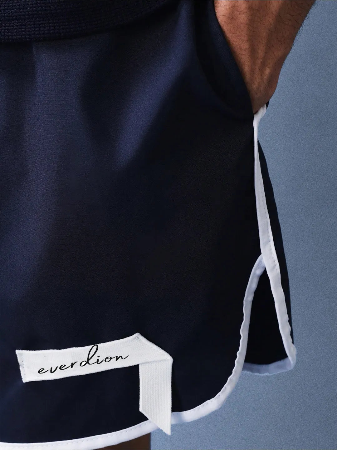 Navy shorts with white trim and 'everdion' branding on a grey background