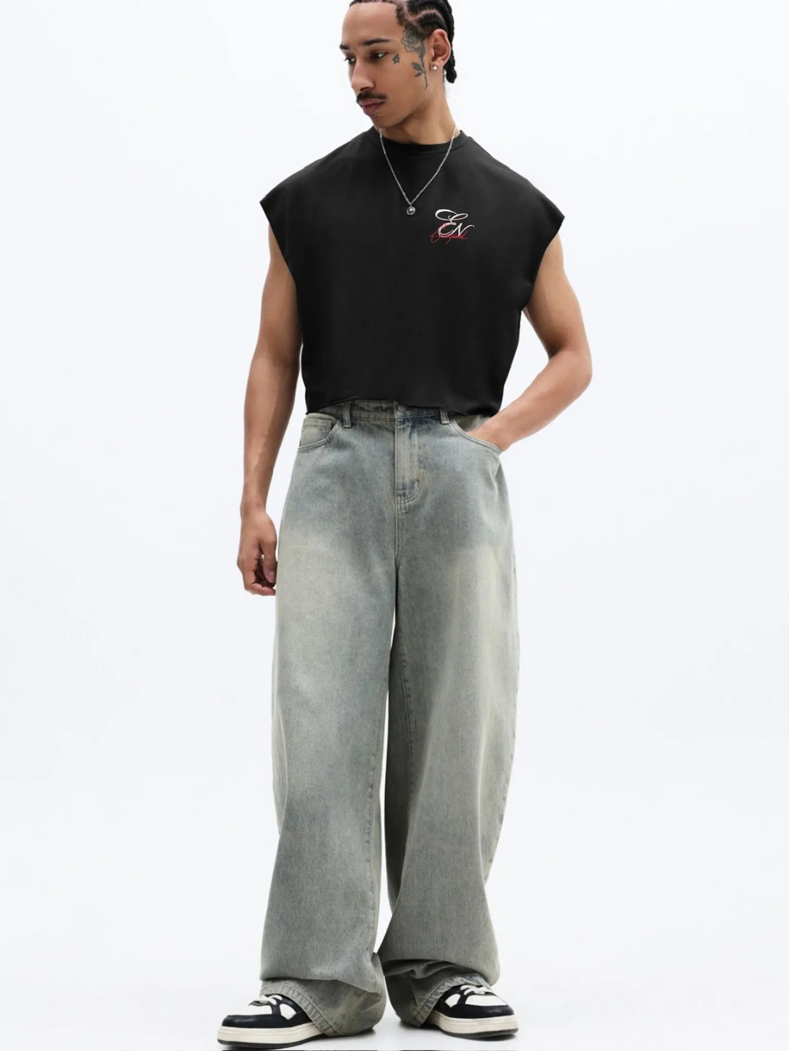 Person wearing a black sleeveless cropped tank top