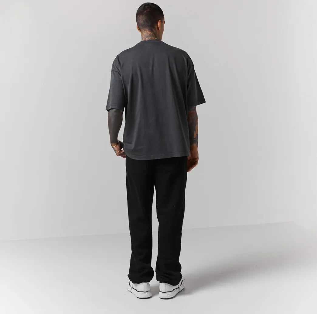 Person wearing black jogger on a white background
