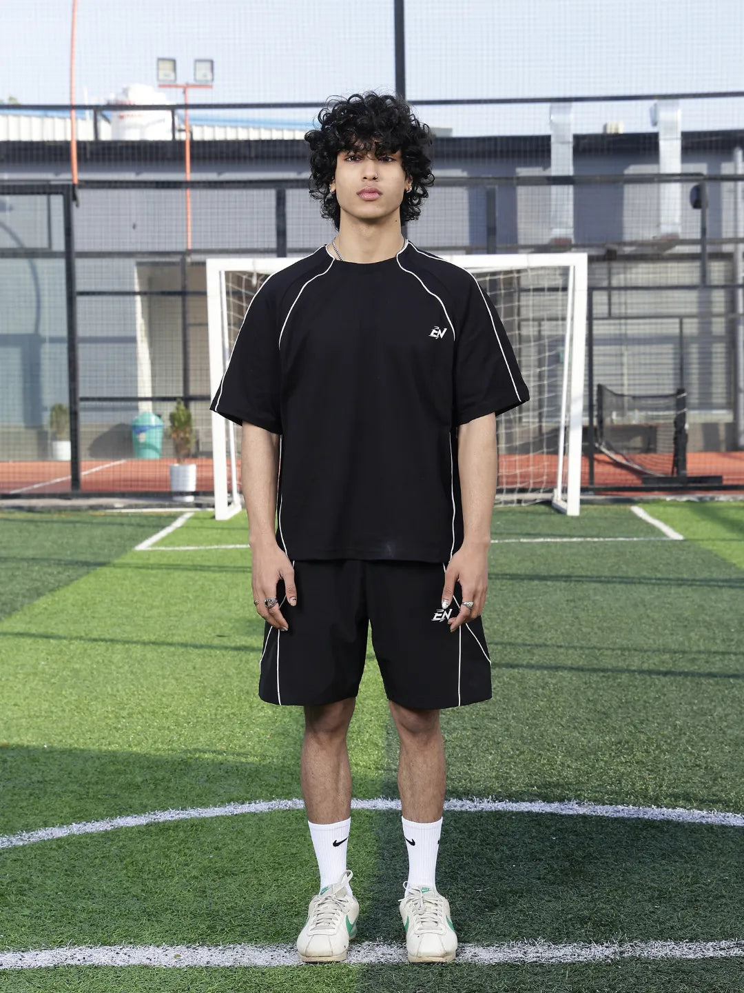 Person wearing a black outfit on a sports field