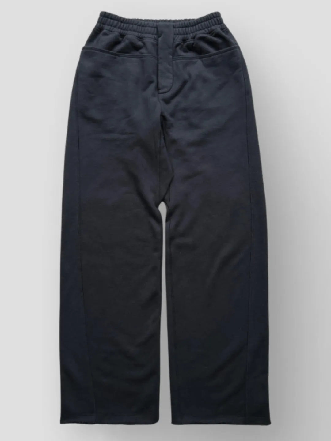 Person wearing button up black sweatpants 
