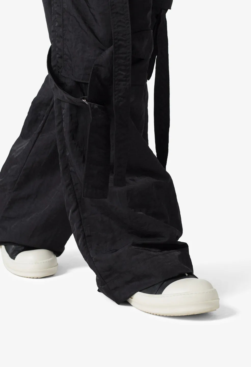 Person wearing black baggy strap cargo pants 